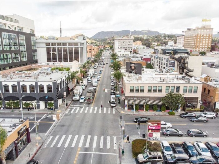 Aerial view of the Cahuenga and Selma corner with the subject building and the Hollywood Hills beyond